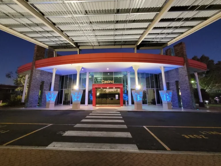 Illuminated entrance to Lasseters Hotel Casino at night